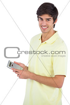 Smiling man using calculator