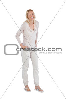 Laughing woman with hands in pockets