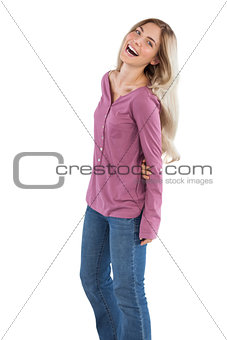 Cheerful woman with arms behind her back