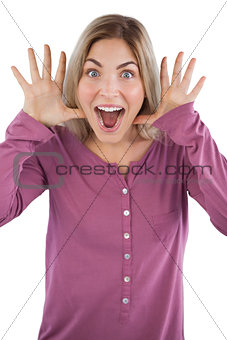 Surprised young woman raising hands