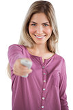 Young woman using remote control