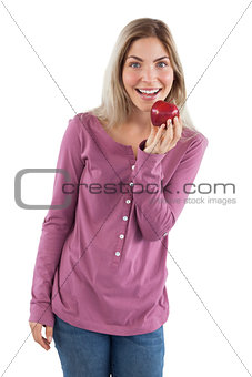 Cheerful woman showing an apple