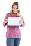Smiling blonde woman holding tablet pc
