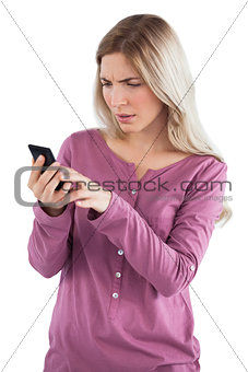 Worried woman sending text message
