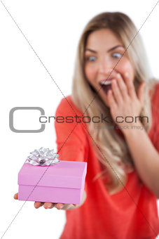 Surprised woman holding a present