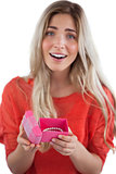 Surprised blonde woman opening gift