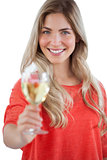 Happy woman showing white wine glass