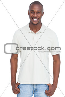 Smiling man with thumbs in pocket