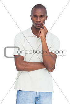 Serious man thinking with hand on chin