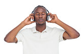 Man with eyes closed listening to music