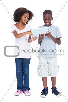 Brother and sister using tablet pc