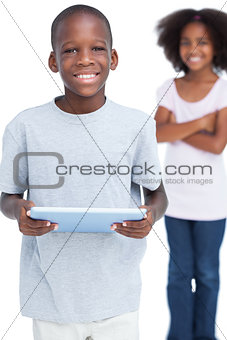 Smiling little boy using tablet pc