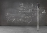 Businessman standing on a giant ladder and writing maths equations