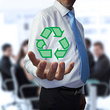 Businessman holding the recycling symbol