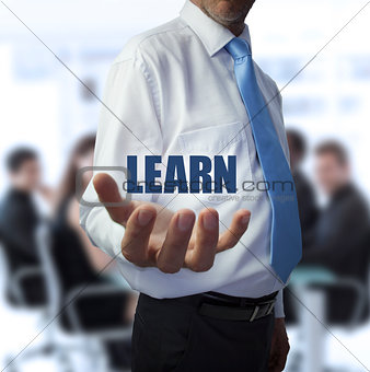 Smart businessman holding the word learn