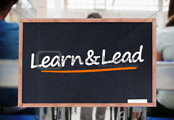 Learn and lead written on blackboard
