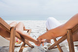 Couple resting on deck chairs