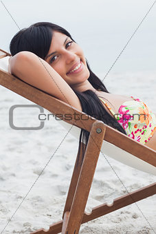 Beautiful woman resting on deck chair