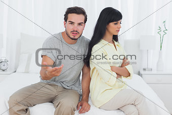 Woman sulking and her boyfriend doesnt know what to do