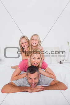 Man giving a piggy back to his family