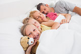 Parents sleeping with their daughters in bed