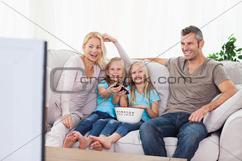 Twins and parents watching television