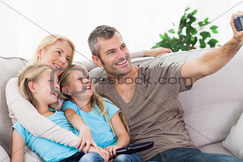Man taking picture of his children and wife