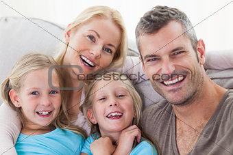 Portrait of parents and twins sitting on a couch