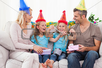 Family wearing party hat and celebrating twins birthday