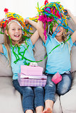 Twins playing with confetti during their birthday