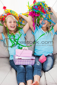 Twins playing with confetti during their birthday