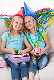 Cute twins unwrapping their birthday present