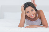 Portrait of a beautiful woman relaxing lying in bed