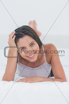 Portrait of an attractive woman relaxing lying in bed