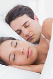 Portrait of a pretty woman sleeping next to her partner