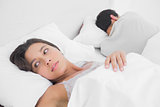 Anxious woman sleeping in bed