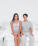 Cheerful couple sitting in bed