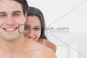 Pretty woman hiding behind shirtless partner