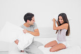Couple playing and having a pillow fight