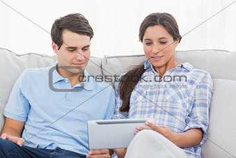 Couple relaxing with a tablet