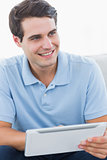 Smiling man using his tablet