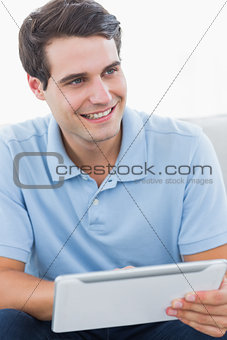 Smiling man using his tablet