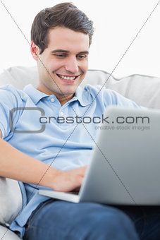 Portrait of a smiling man using his laptop