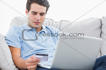 Man using his credit card to purchase online