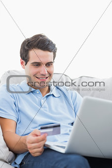 Man using his credit card to buy online