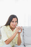 Portrait of a pretty woman holding a cup of coffee