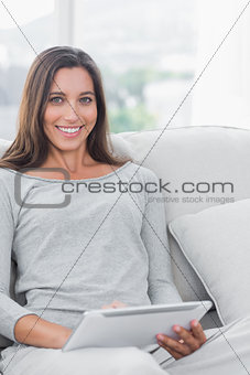 Cheerful woman using a tablet