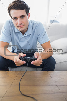 Man playing video games while he is sat on a couch