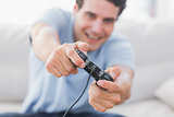 Portrait of a smiling man playing video games