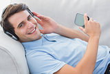 Portrait of a man enjoying music with his smartphone